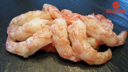 A photograph of raw peeled and deveined Argentine red shrimp.